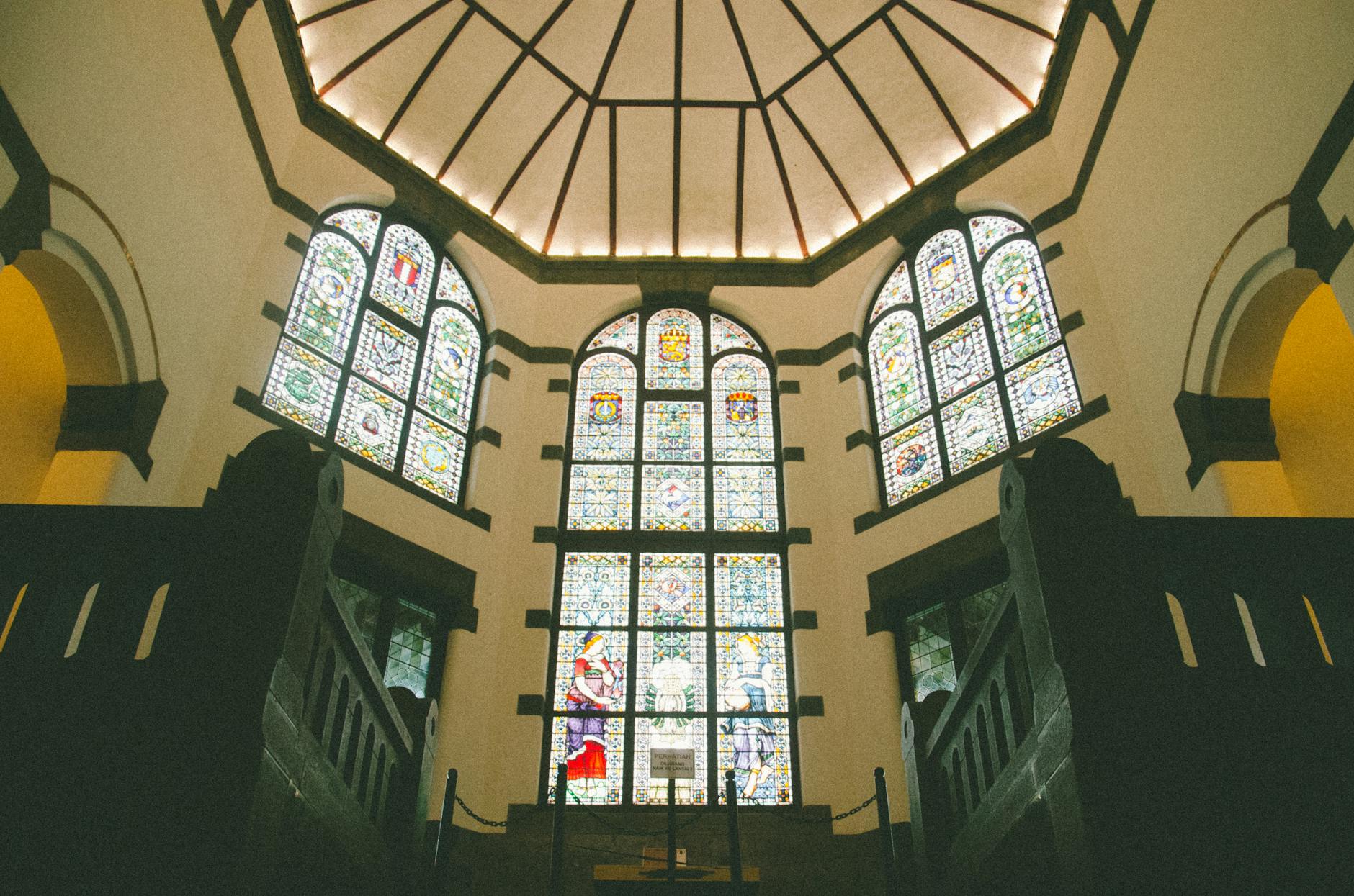 Zabytkowe witraże we wnętrzu historycznego budynku przypominającym kościół